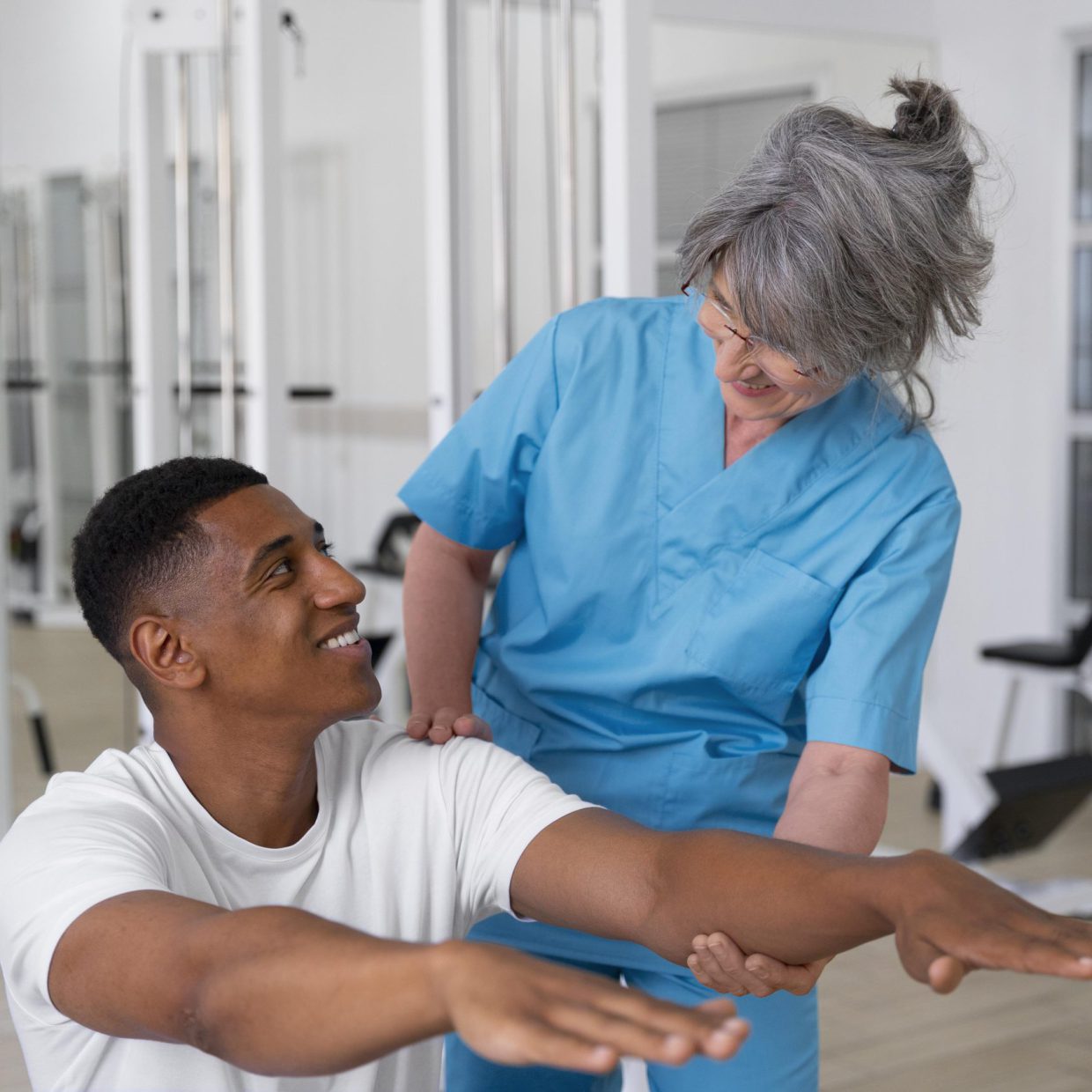 medical-assistant-helping-patient-with-physiotherapy-exercises medical-assistant-helping-patient-with-physiotherapy-exercises